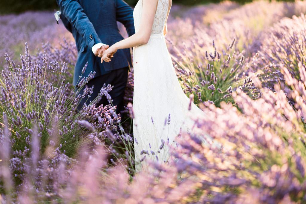 Zoe and Daniel walk through the lavender fields of Zoe and Daniel walk down the aisle at their wedding at Zoe and Daniel share their first kiss as husband and wife at Woodinville Lavender Farm, Washington, summer 2016
