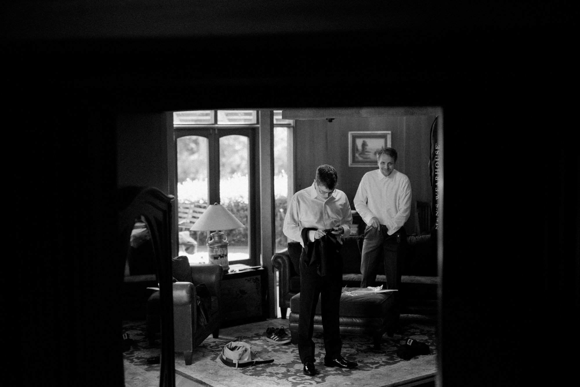 Graeme, the groom, gets ready with his groomsmen at Kingston House, a wedding venue in Kingston, Washington.