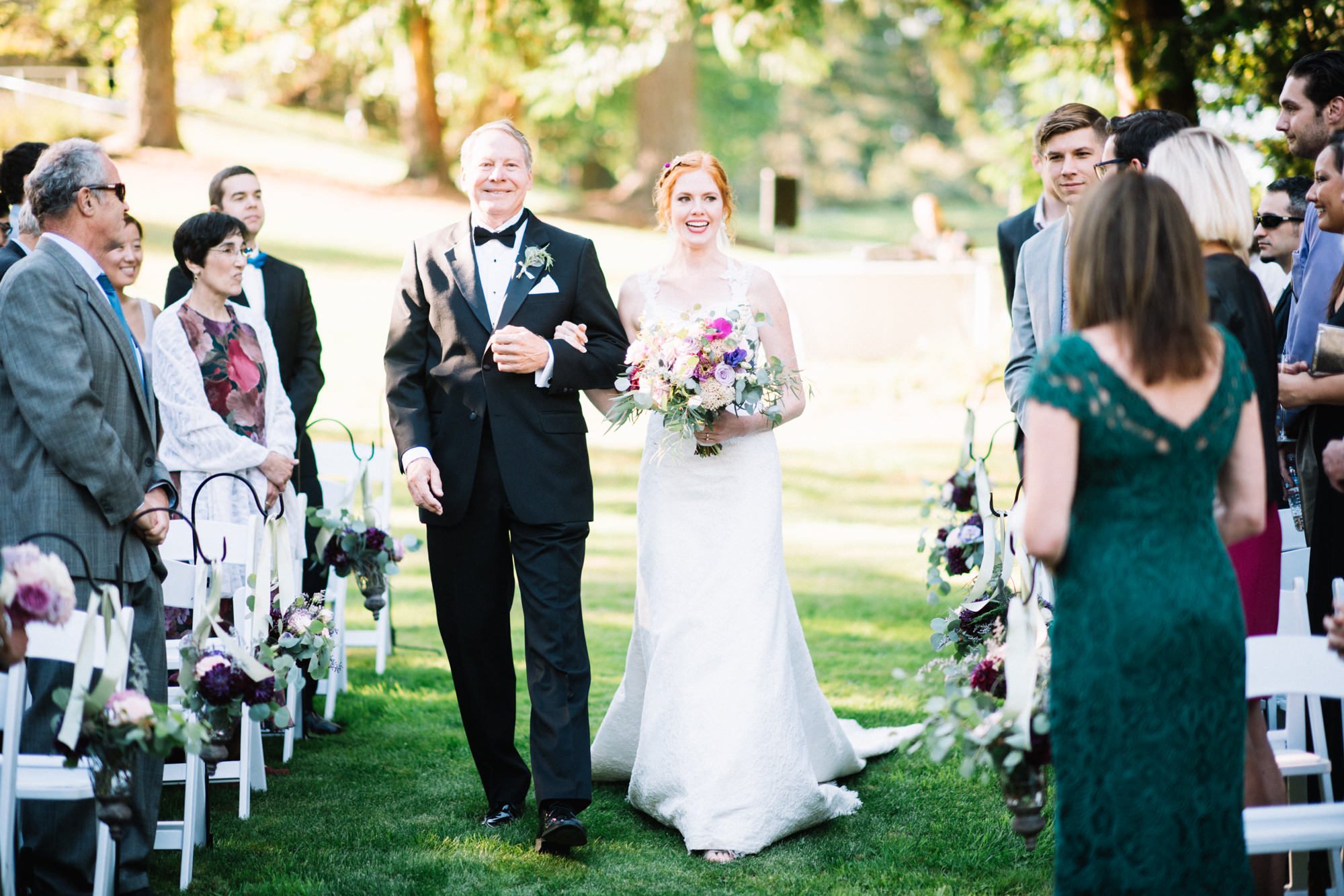 Katherine and her dad walk down the aisle during the wedding ceremony at Kingston House, WA