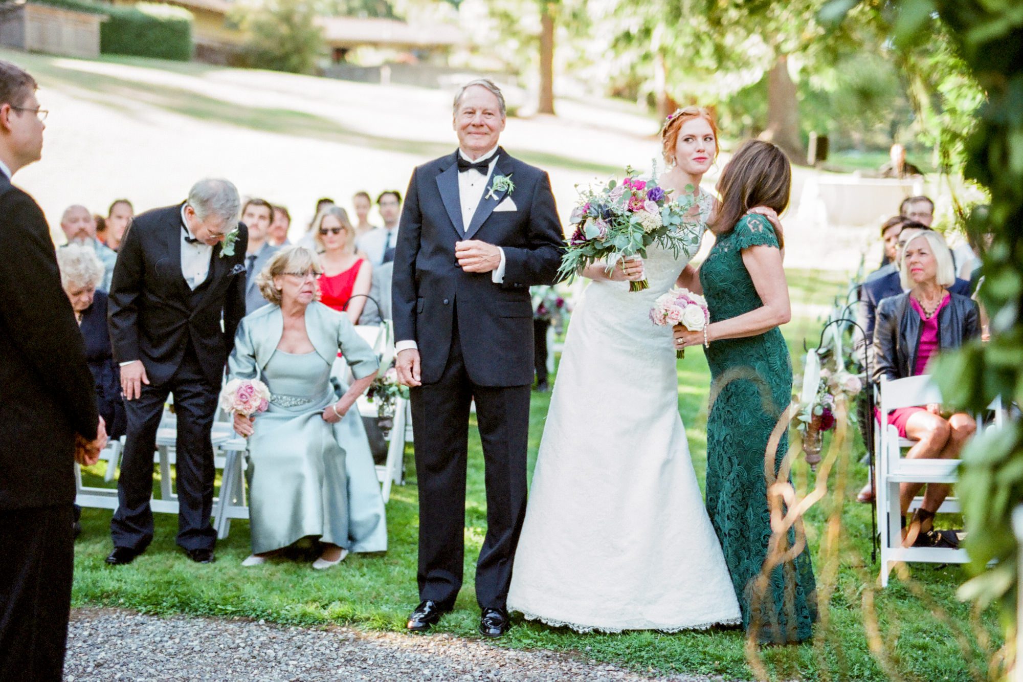 Katherine gives her mom a kiss at the front of the aisle during her wedding at Kingston House, WA. September 2016