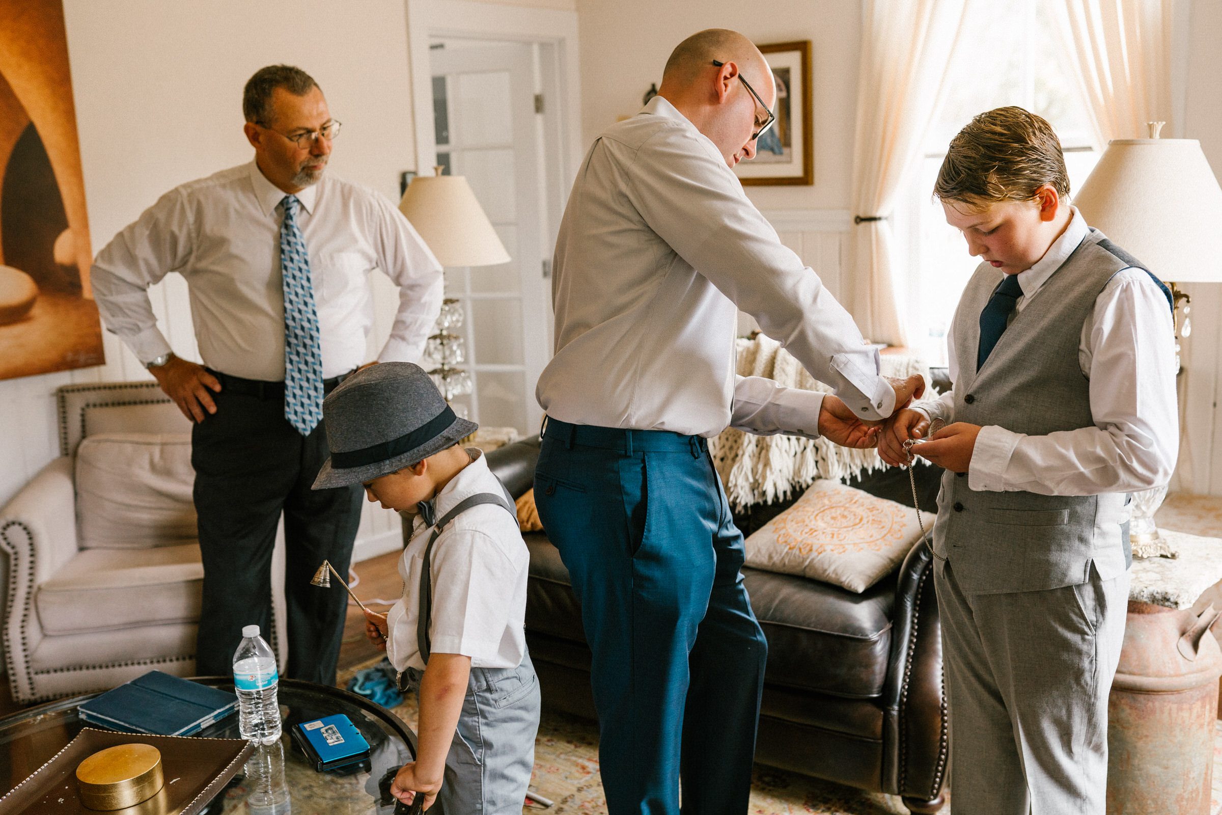 Wayfarer Whidbey Island Wedding: Funny candid of the groom and his sons getting ready.