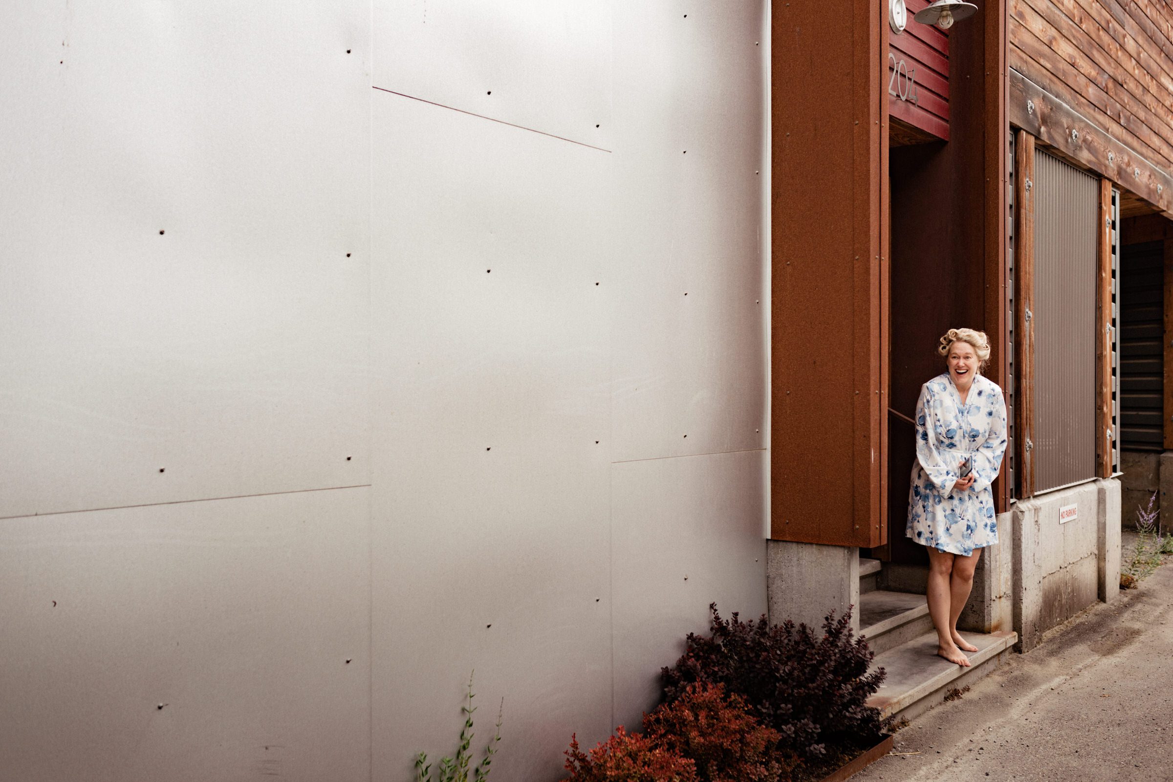 Whidbey Island Wedding: Sara, the bride, greets us at the entrance of her suite at the Boatyard Inn