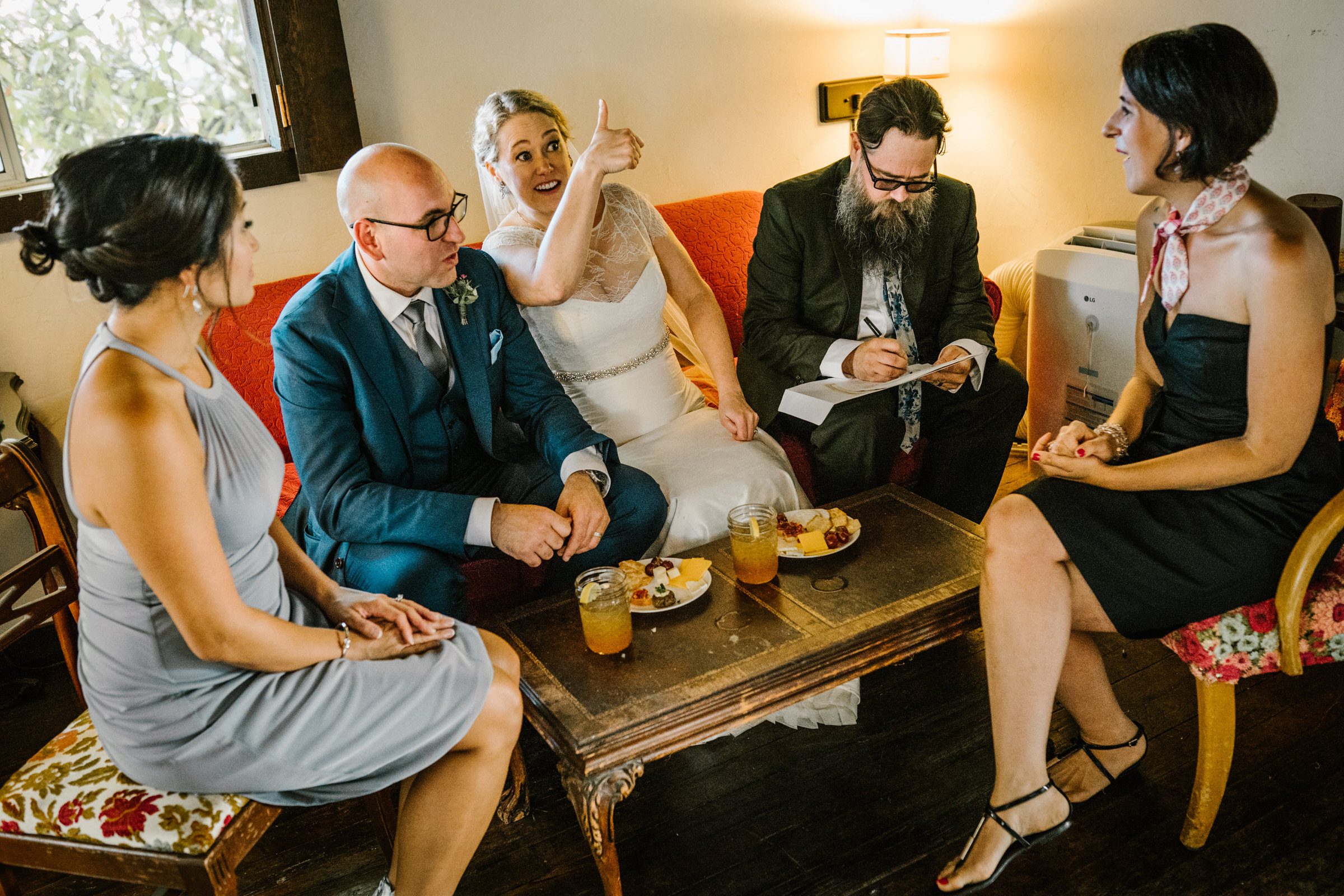 Wayfarer Whidbey Island Wedding: BRide gives a thumbs up to a well wishing guest while they sign their documents