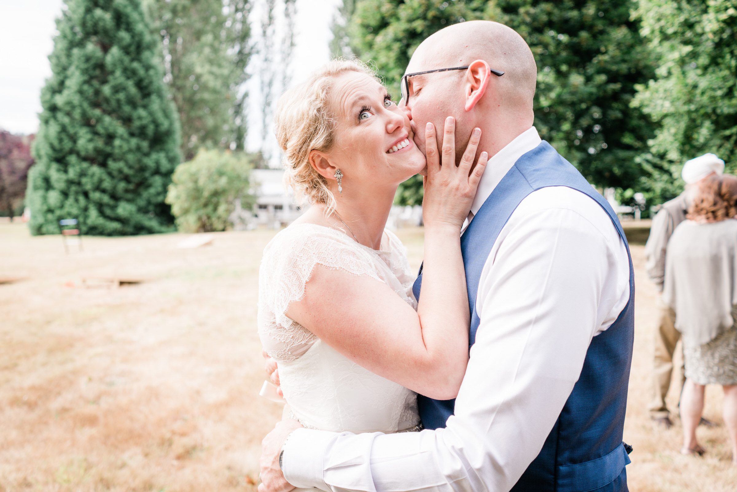 Wayfarer Whidbey Island Wedding: Groom Joe gives bride Sara a peck 