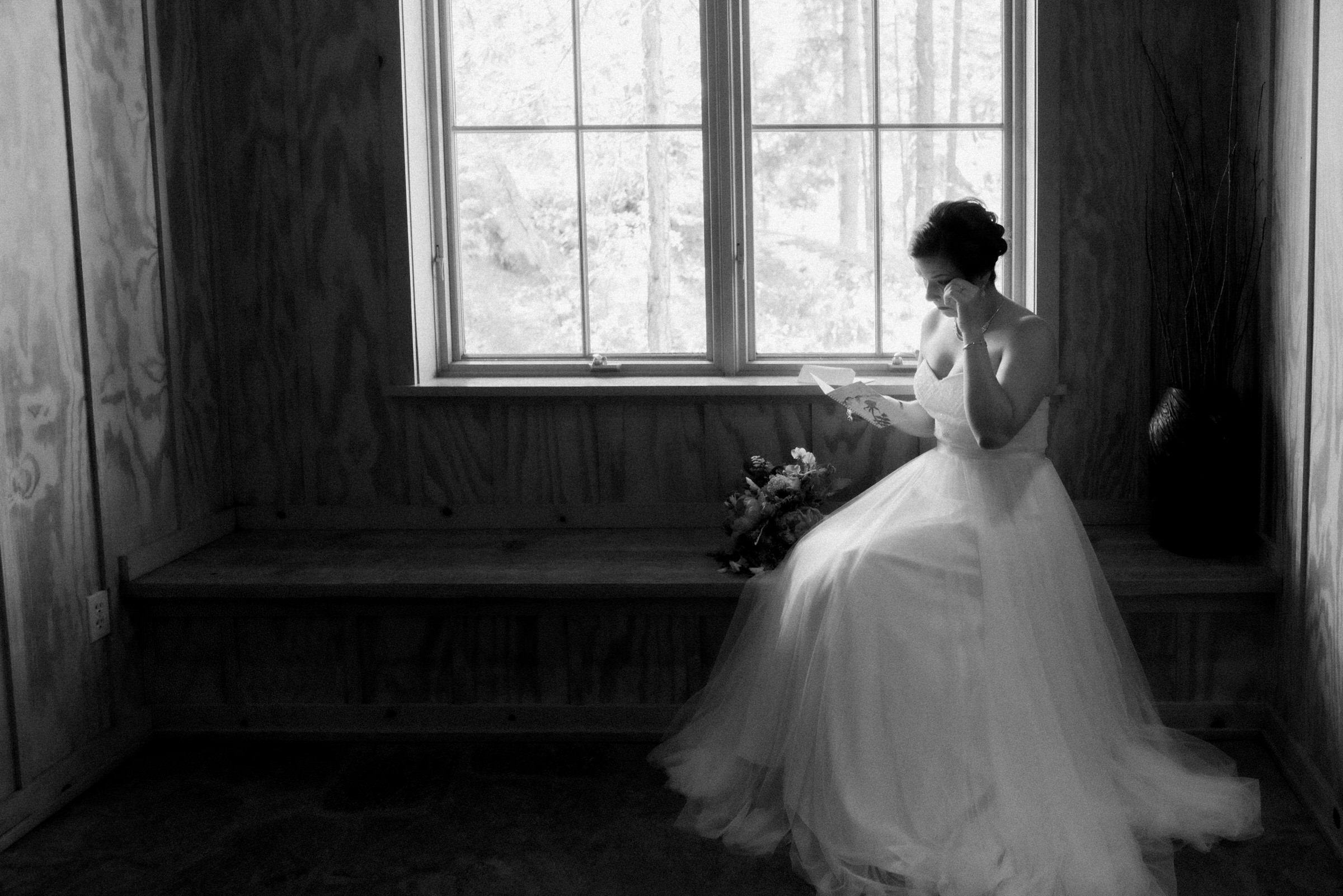 Sleeping Lady Resort weddings: Bride Kristen reads a card from Russ, her groom