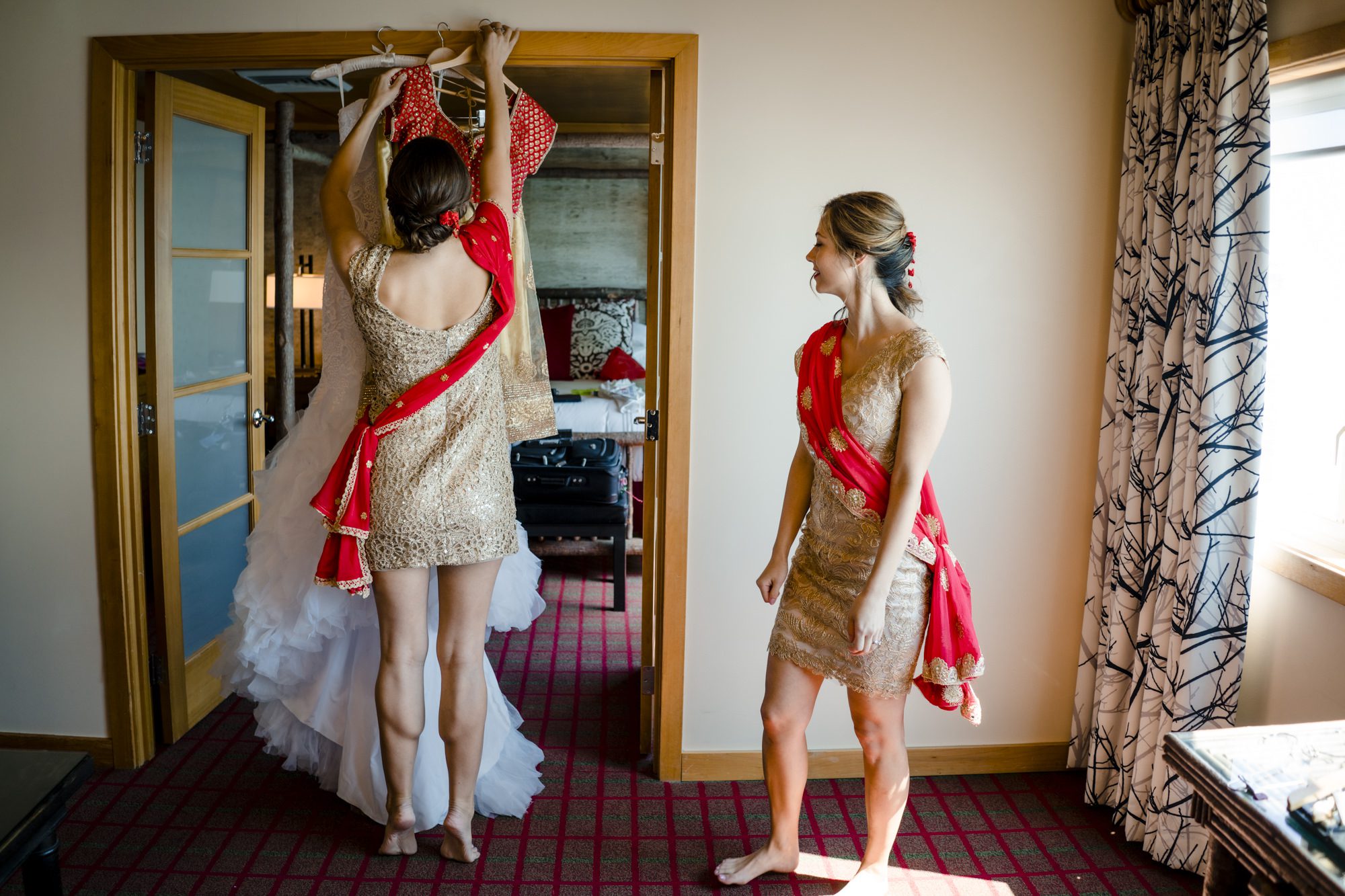 Bridesmaids getting wedding gown down. Photo by Jenn Tai, Seattle Wedding Photographer