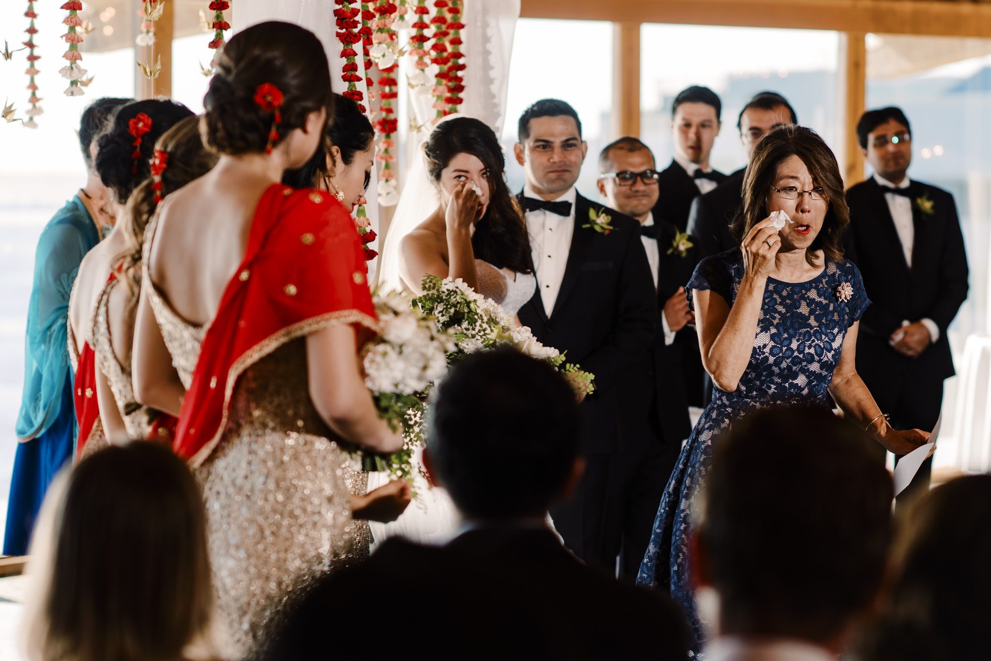 Bride Kelly and mom wipe tears away after reading.