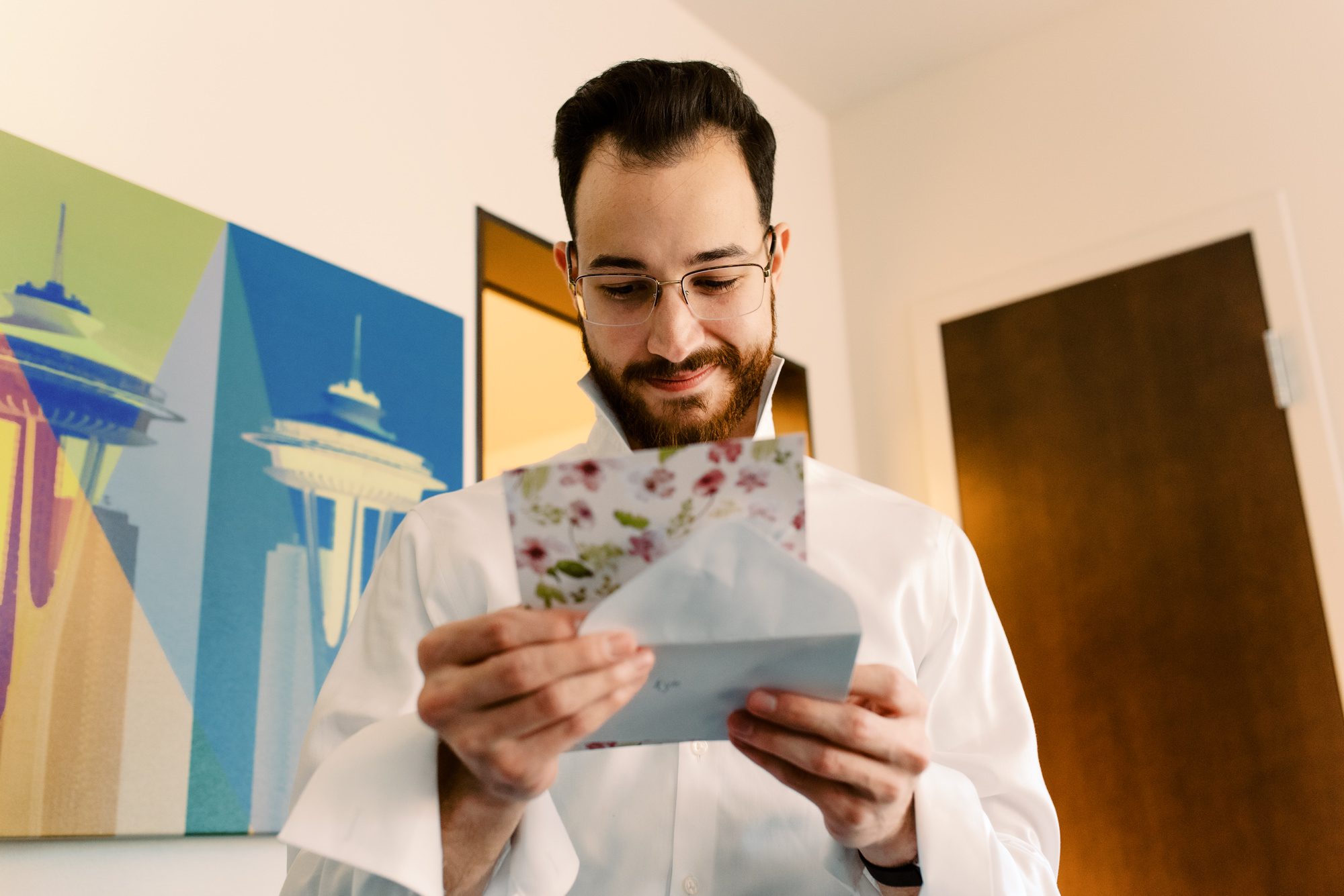 Groom Kyle reads a card from bride Lauren