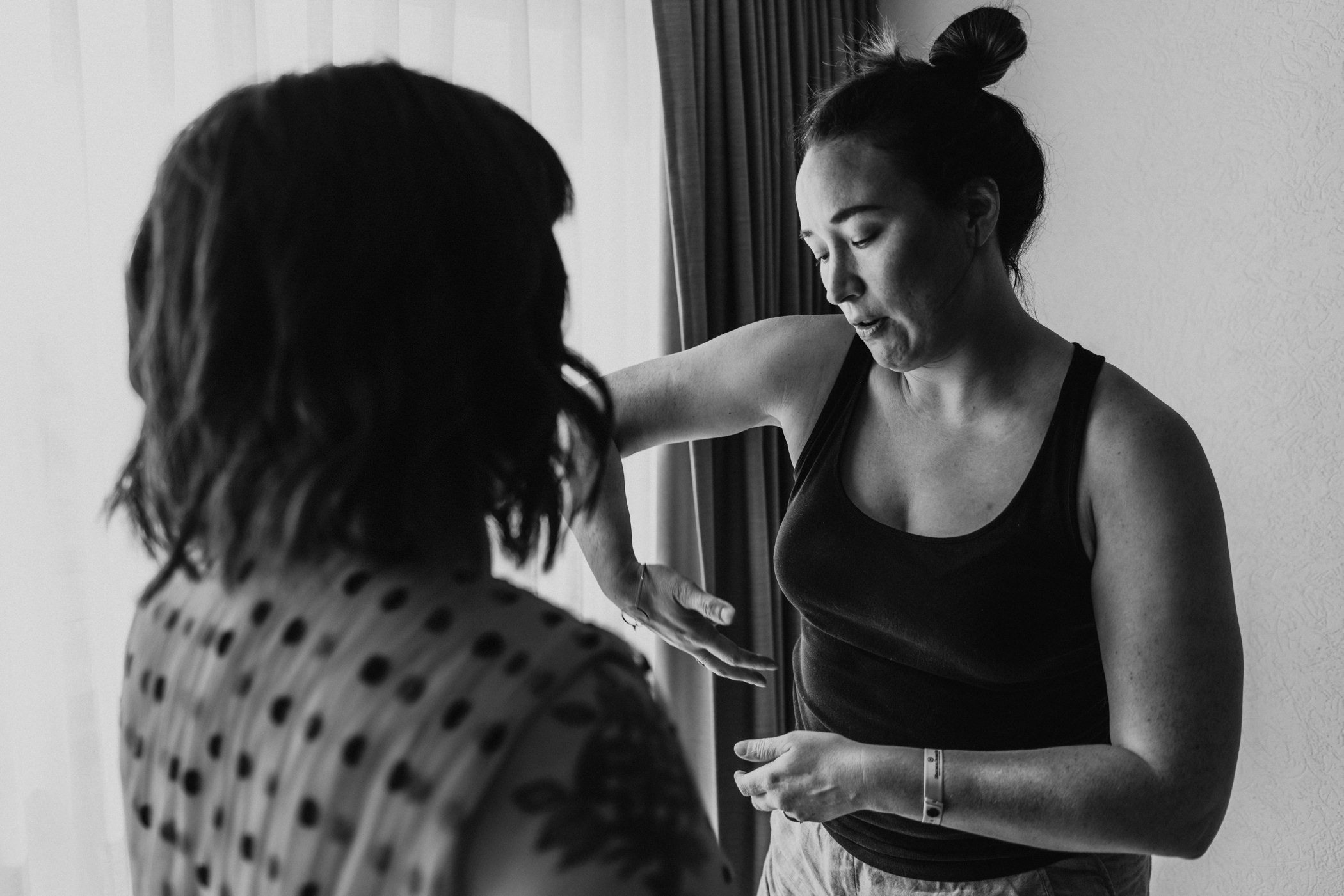 Funny photo of Jenny instructing her sister on how to scoop boobs