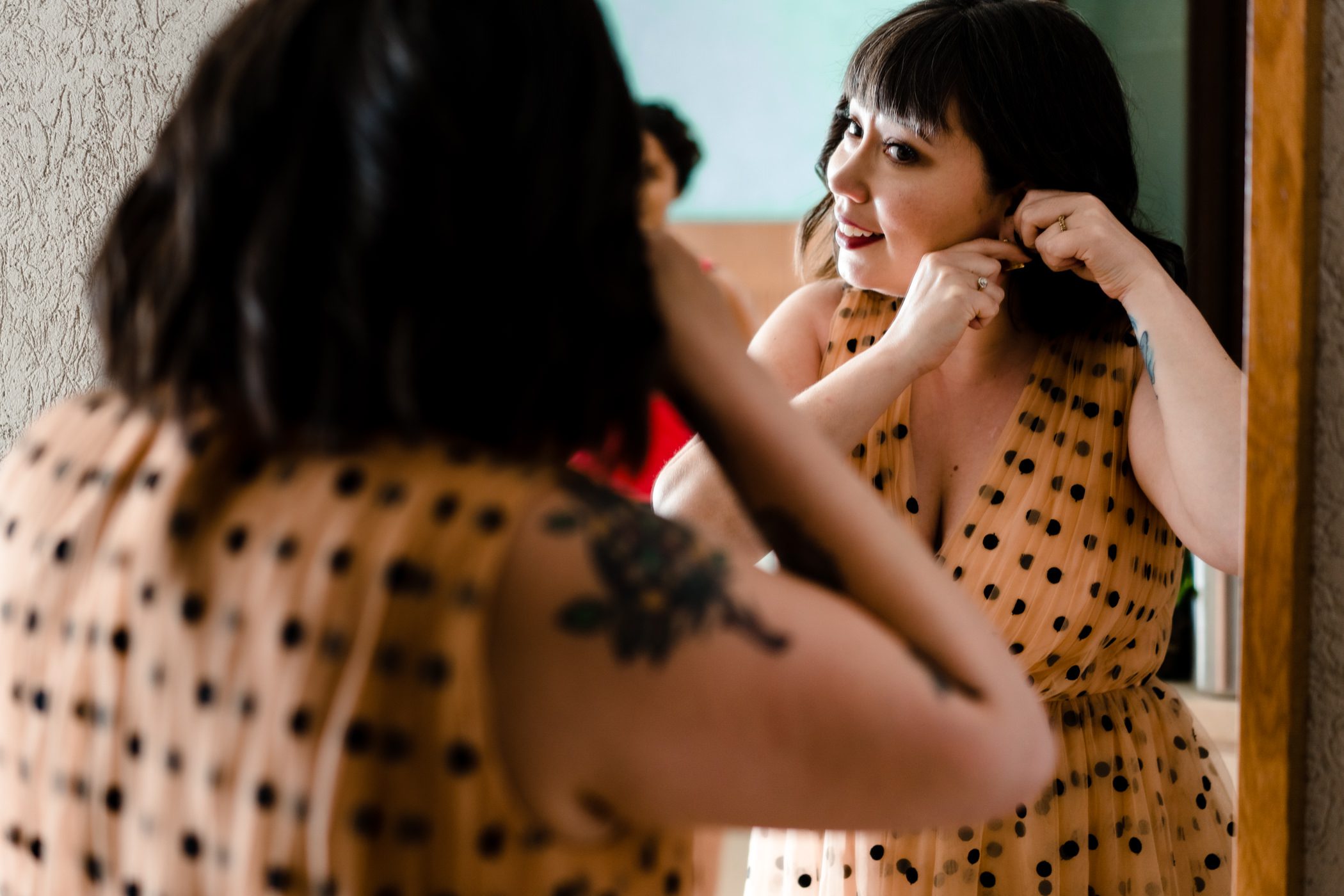 Faythe putting on earrings for her wedding