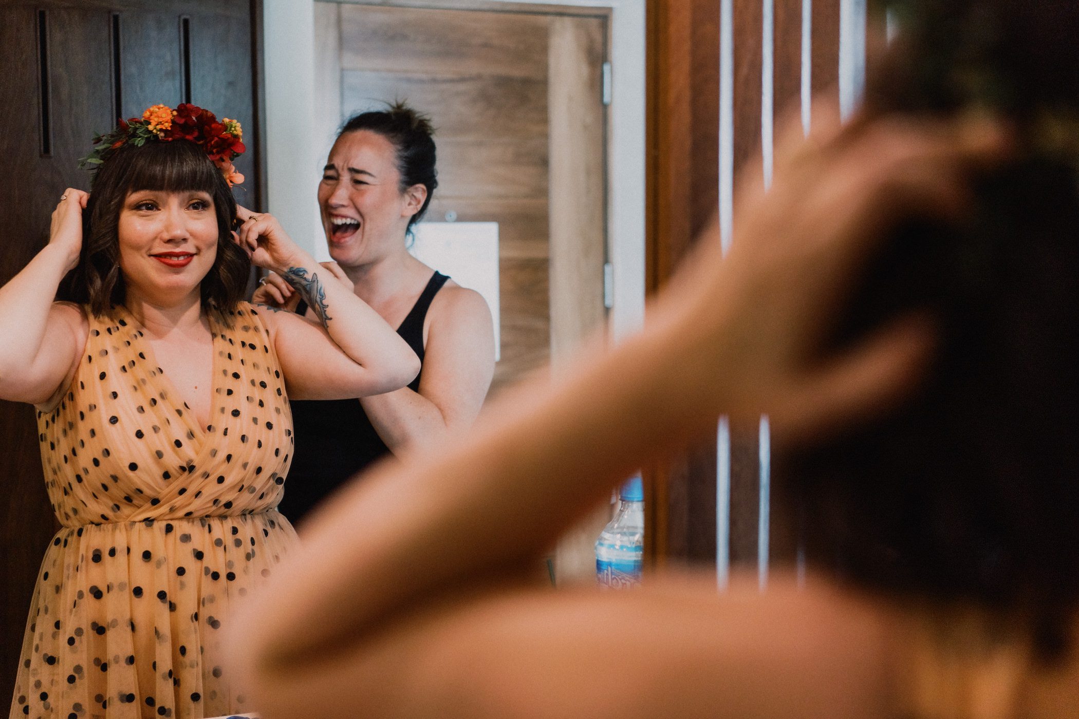 Faythe putting on her floral crown for her wedding.
