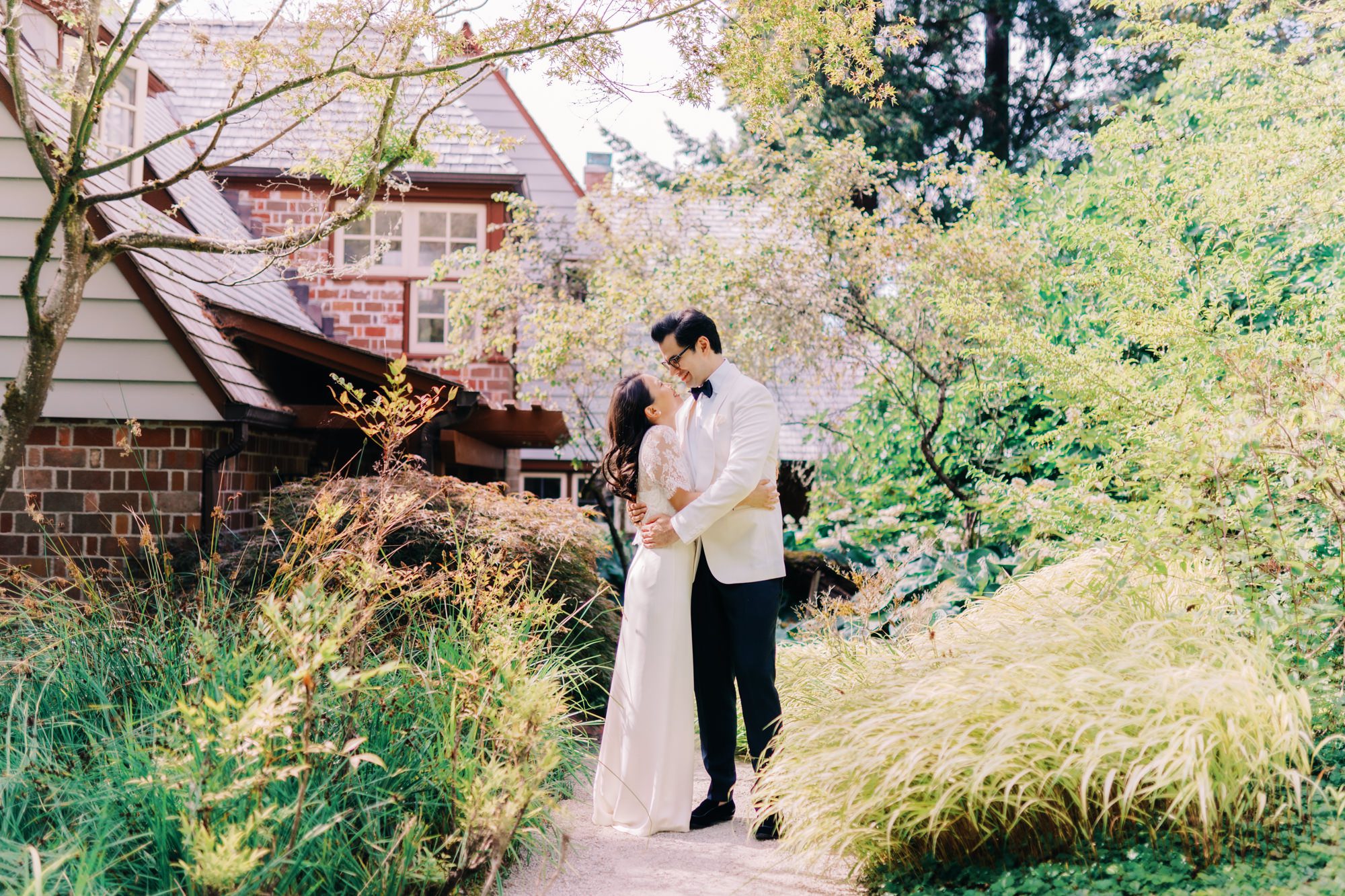 Jen and Sage pose for their wedding portraits at their backyard garden wedding.
