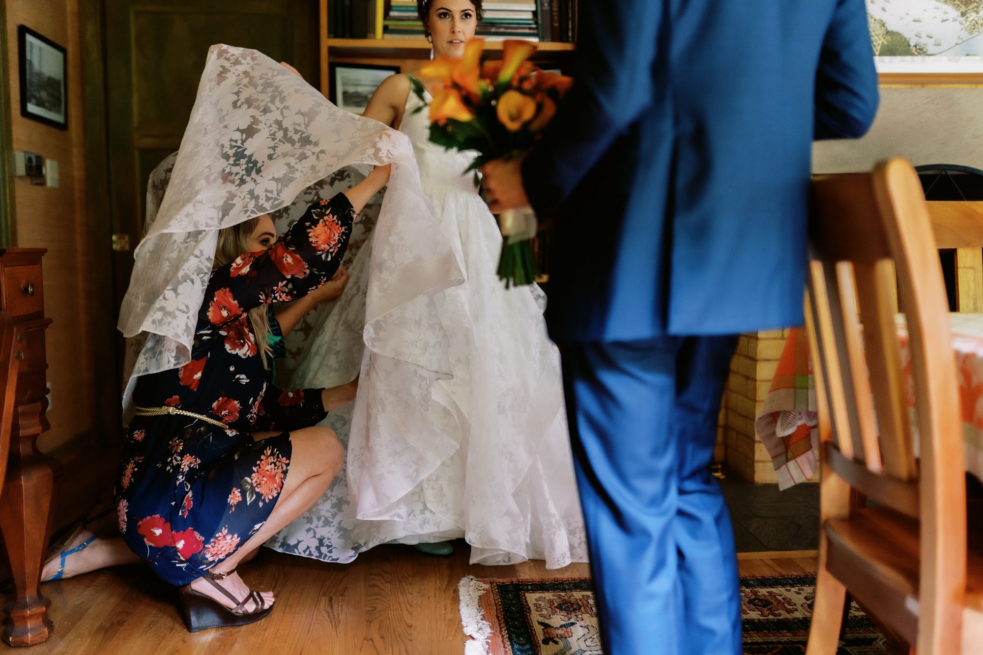 Bride Amy gets her dress bustled