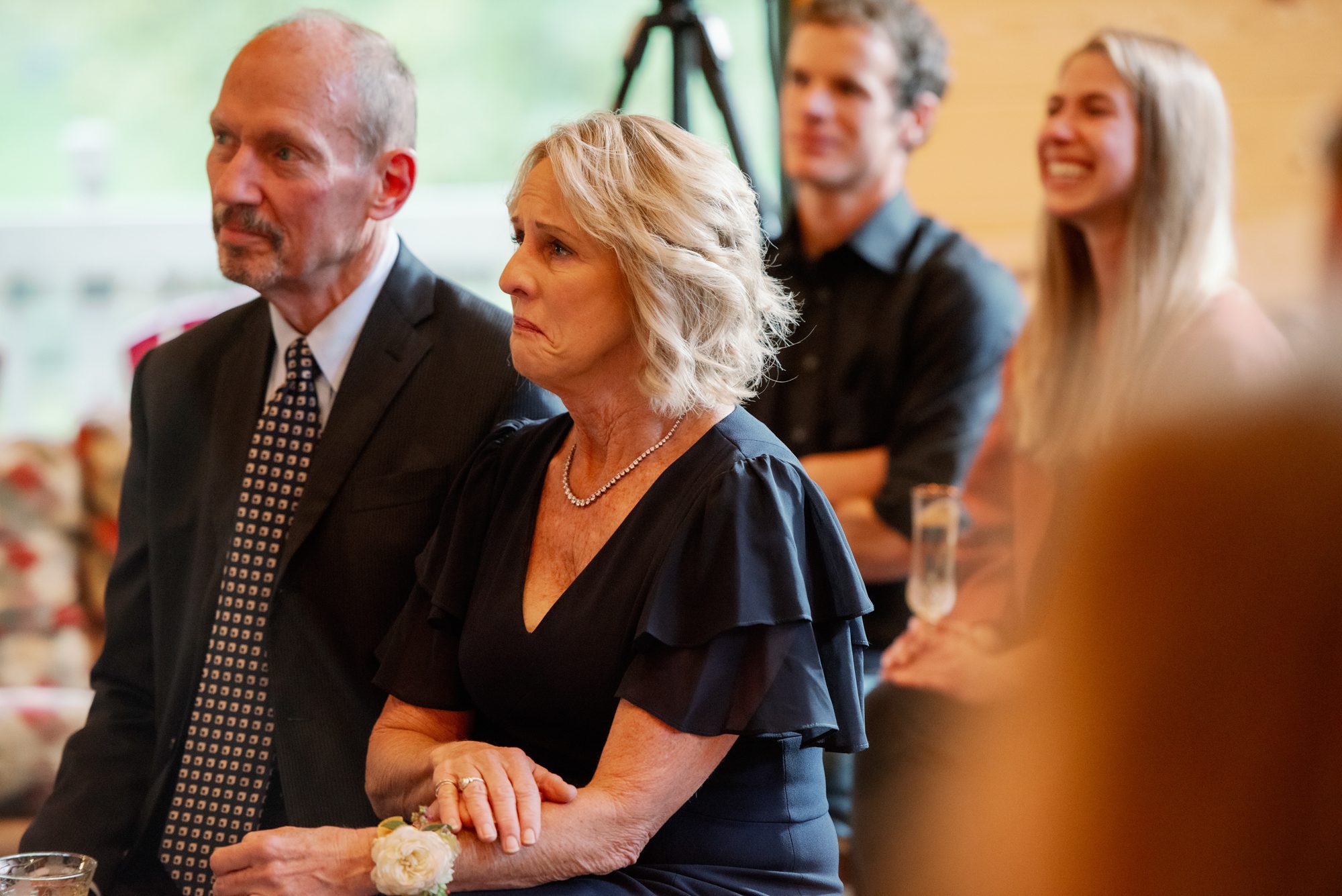 Fletcher's mom and stepdad look on