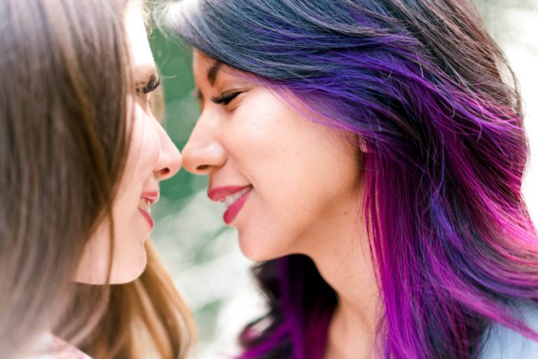 Two women smiling and about to kiss during an engagement photo session with Jenn Tai & Co - Seattle wedding photography