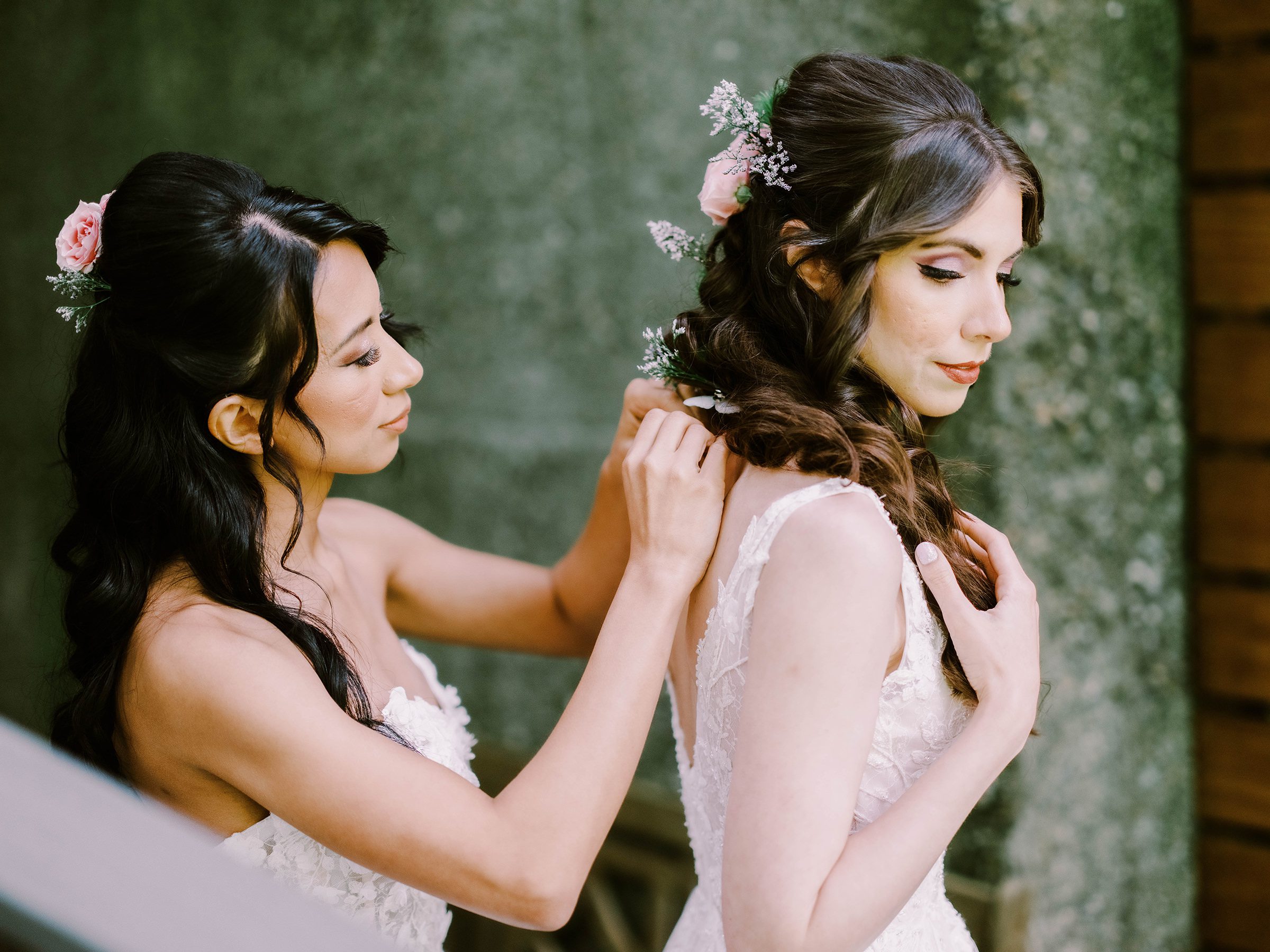 Erika helps her bride Megan get dressed