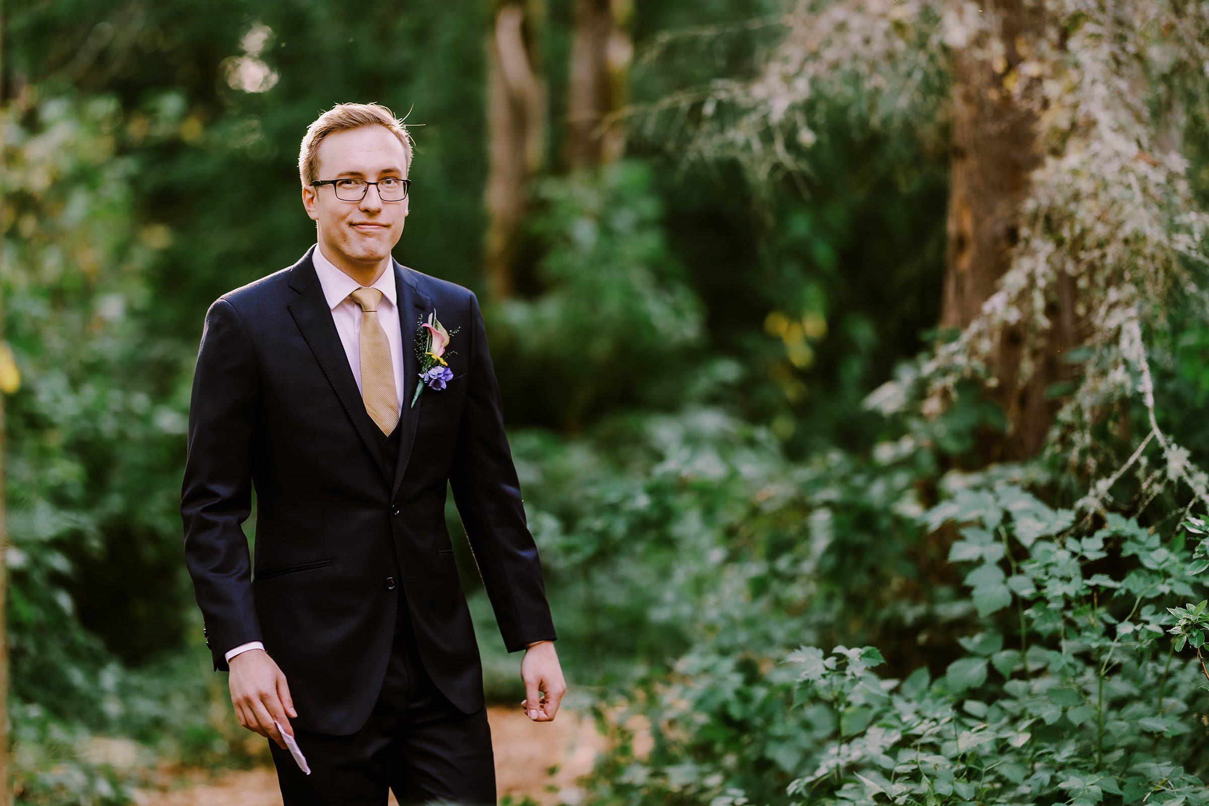 Groom Sean walking to his wedding ceremony in his backyard