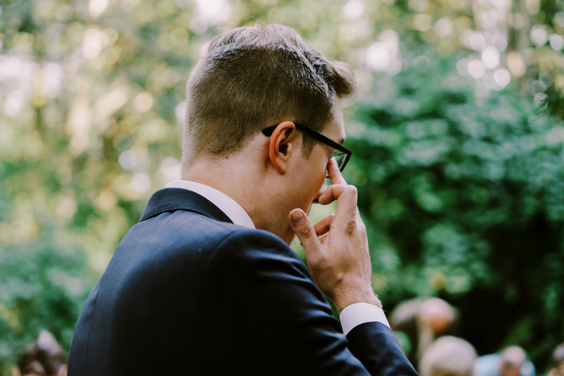 Sean tearing up at his wedding ceremony as his bride Annika walks to him.