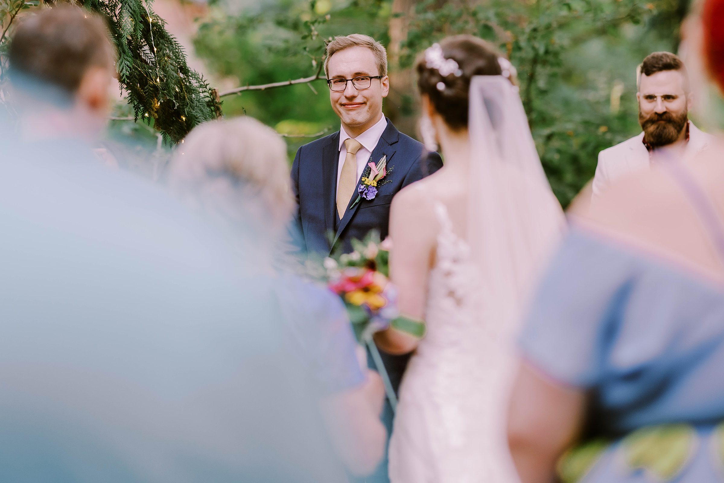 Sean tearing up at his wedding ceremony as his bride Annika walks to him.