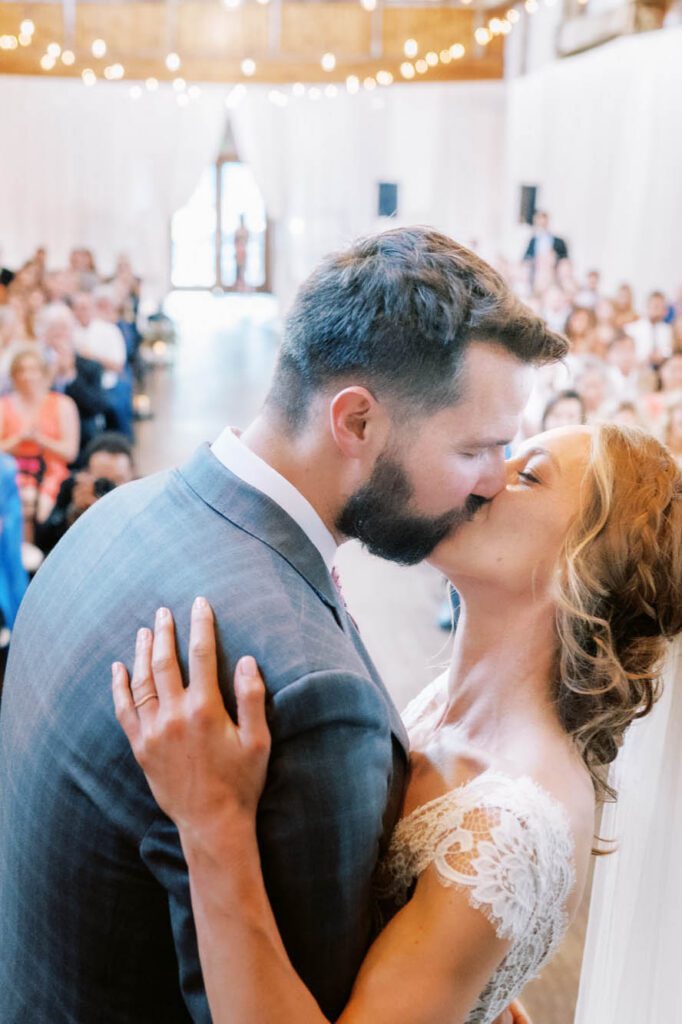 Bride and groom kissing at the altar at Sodo Park wedding venue, photo by Seattle Wedding Photographer JENN TAI